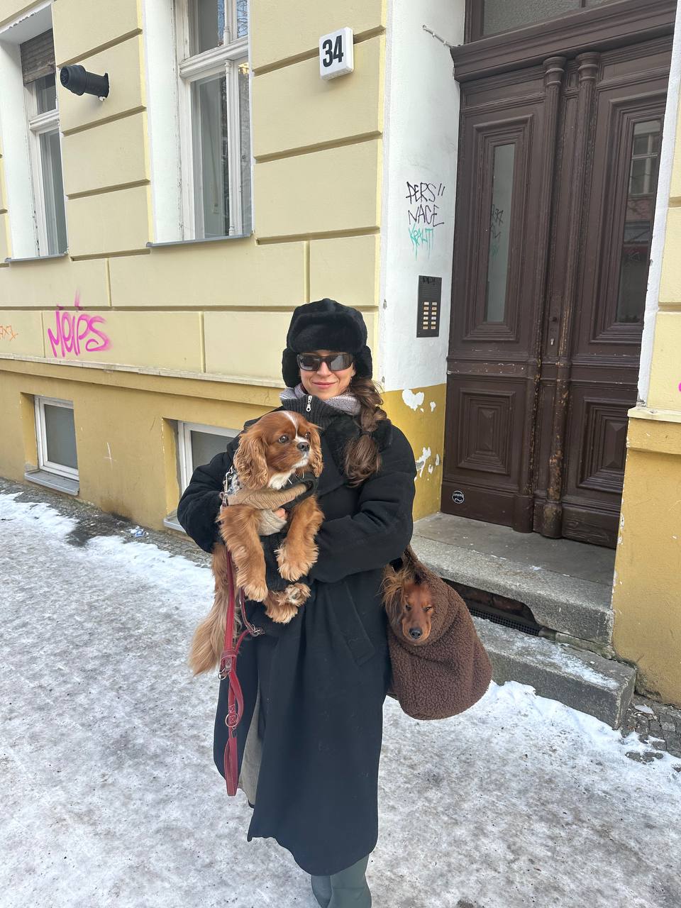 Lara standing outside in Berlin with Olaf and Januk on a winter walk